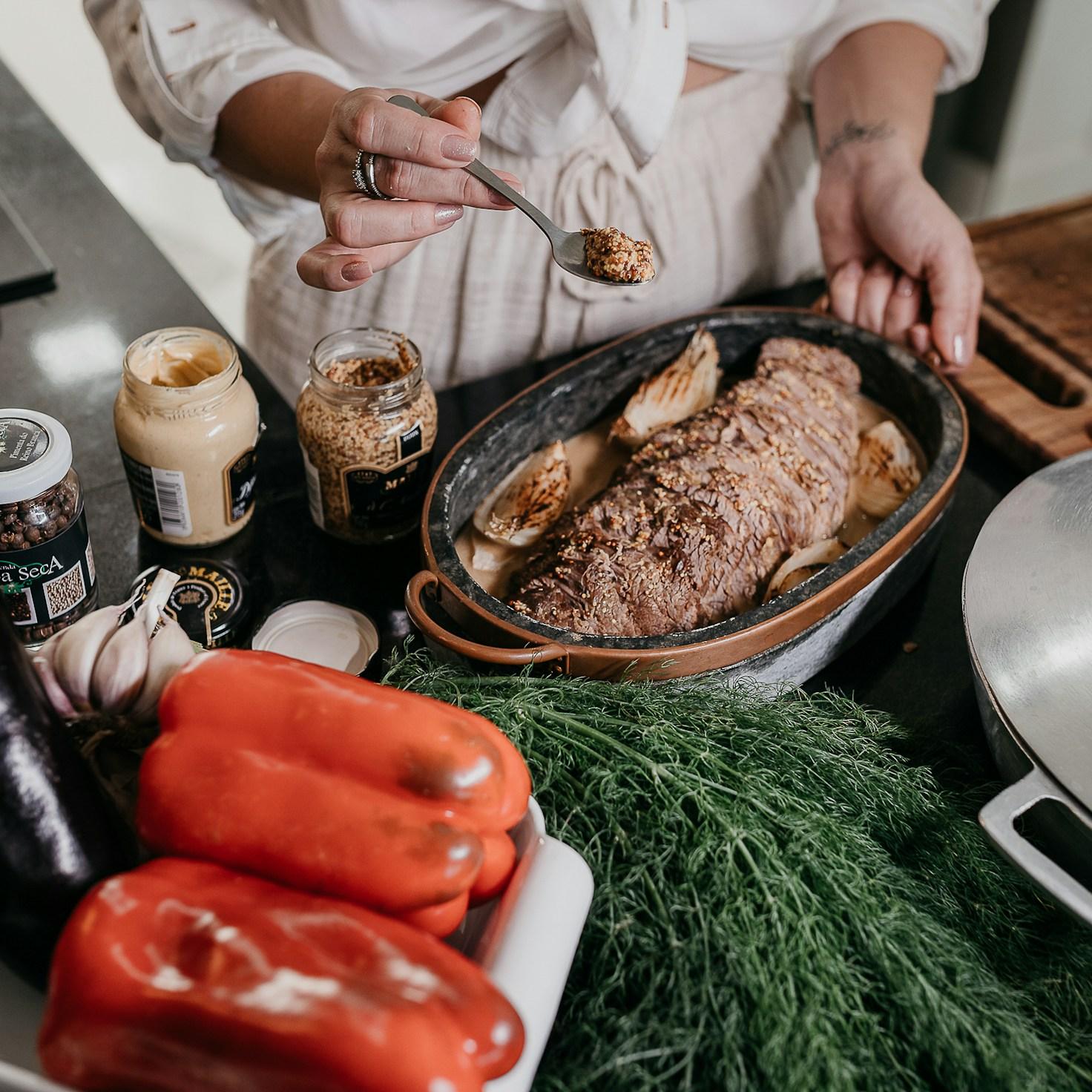 People collaborating in a contemporary kitchen, exchanging recipes and cooking techniques